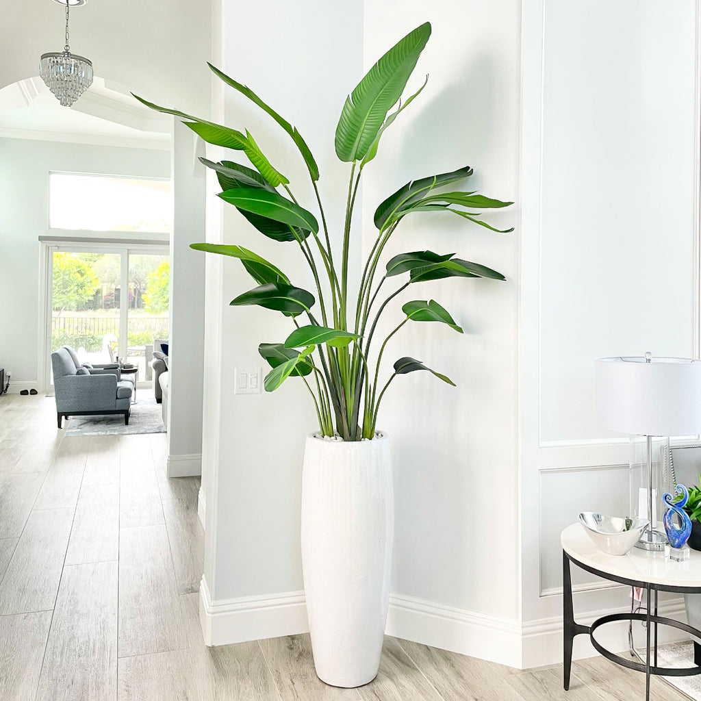 A faux 7' tall travellers palm tree in a tall planter in Palm Beach Gardens