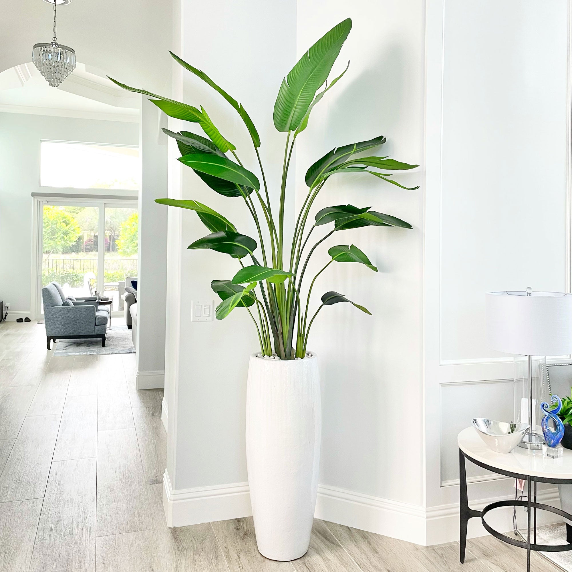 A faux 7' tall travellers palm tree in a tall planter in Palm Beach Gardens