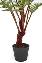 Close-up of the faux woodland fern's trunk and fronds